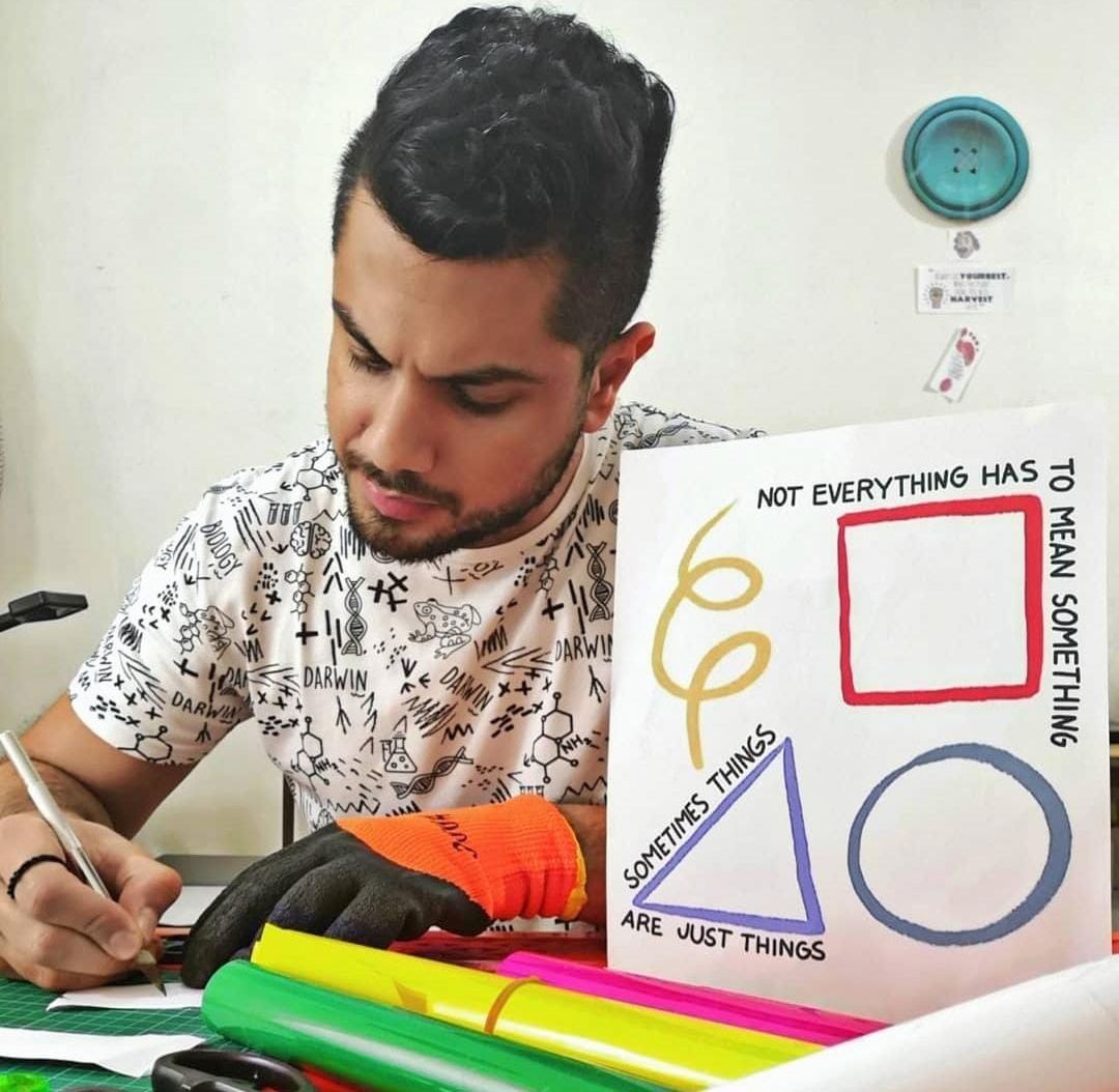 A man sitting in a workplace and crafting  a customized printed gift in Beirut, Lebanon. 