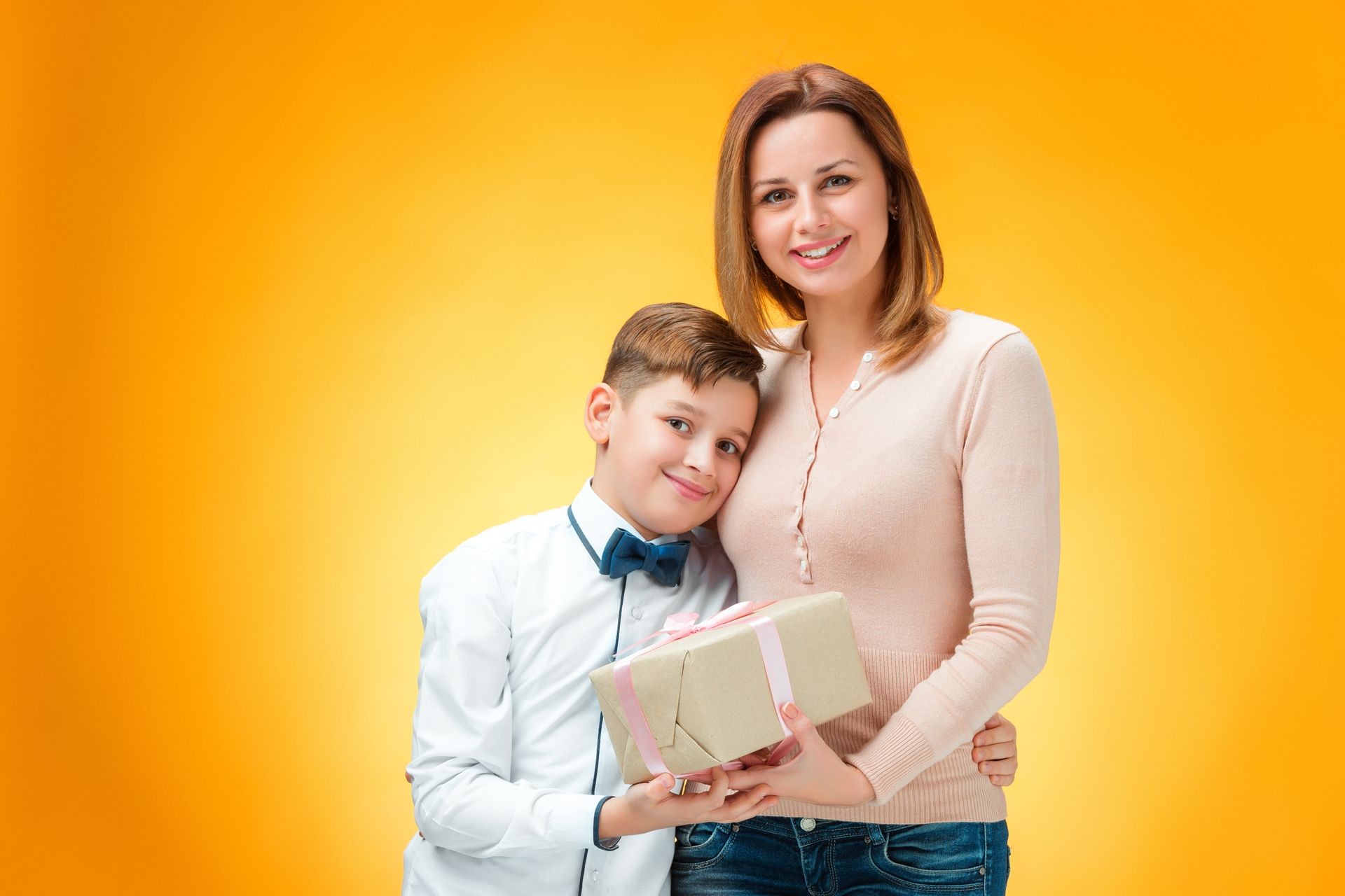 A boy and his mother holding customized gift celebrating Mother's day