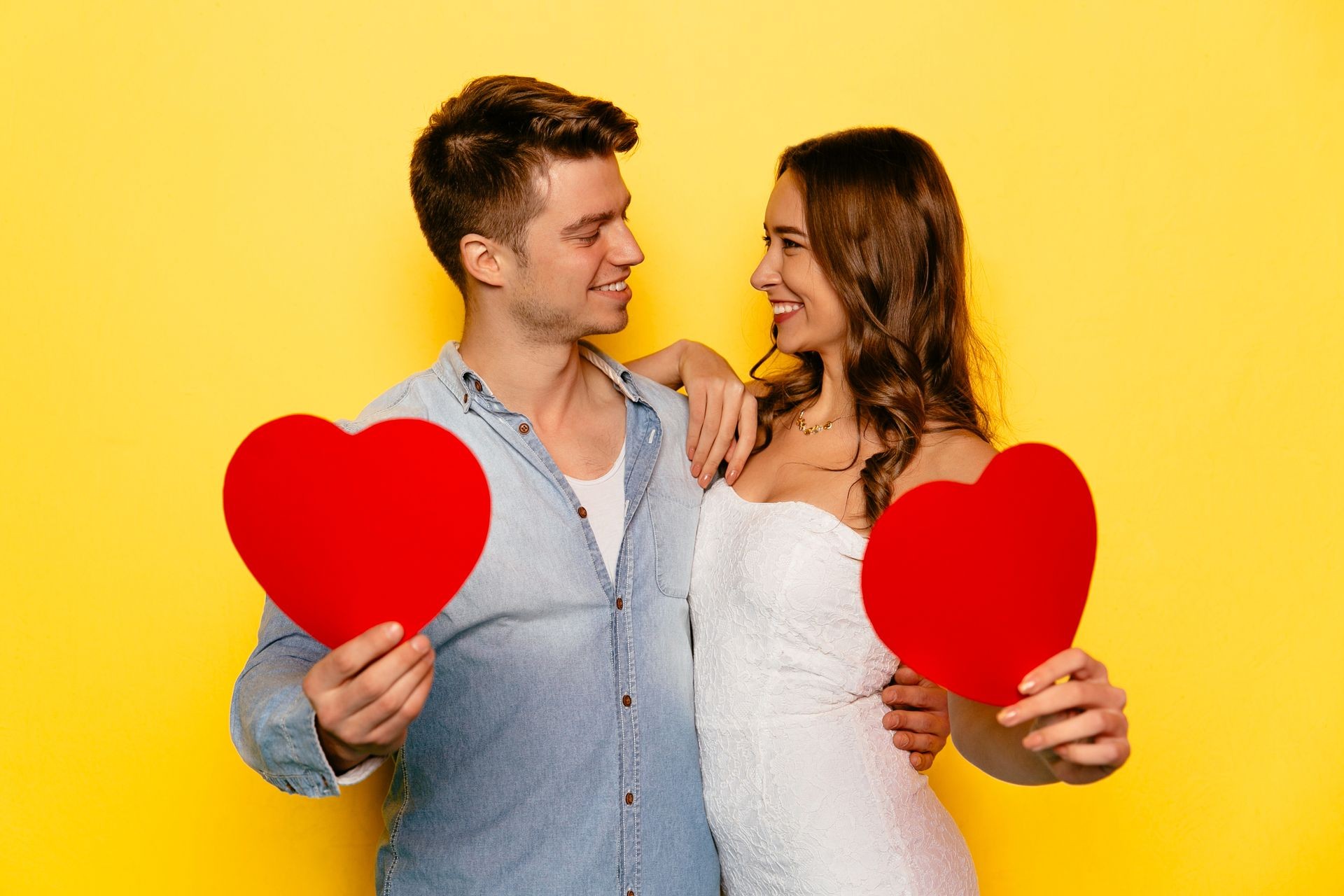 A boy and girl holding customized gift celebrating Valentine's day